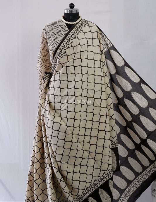 Mannequin wearing a patterned beige and black scarf on a white background